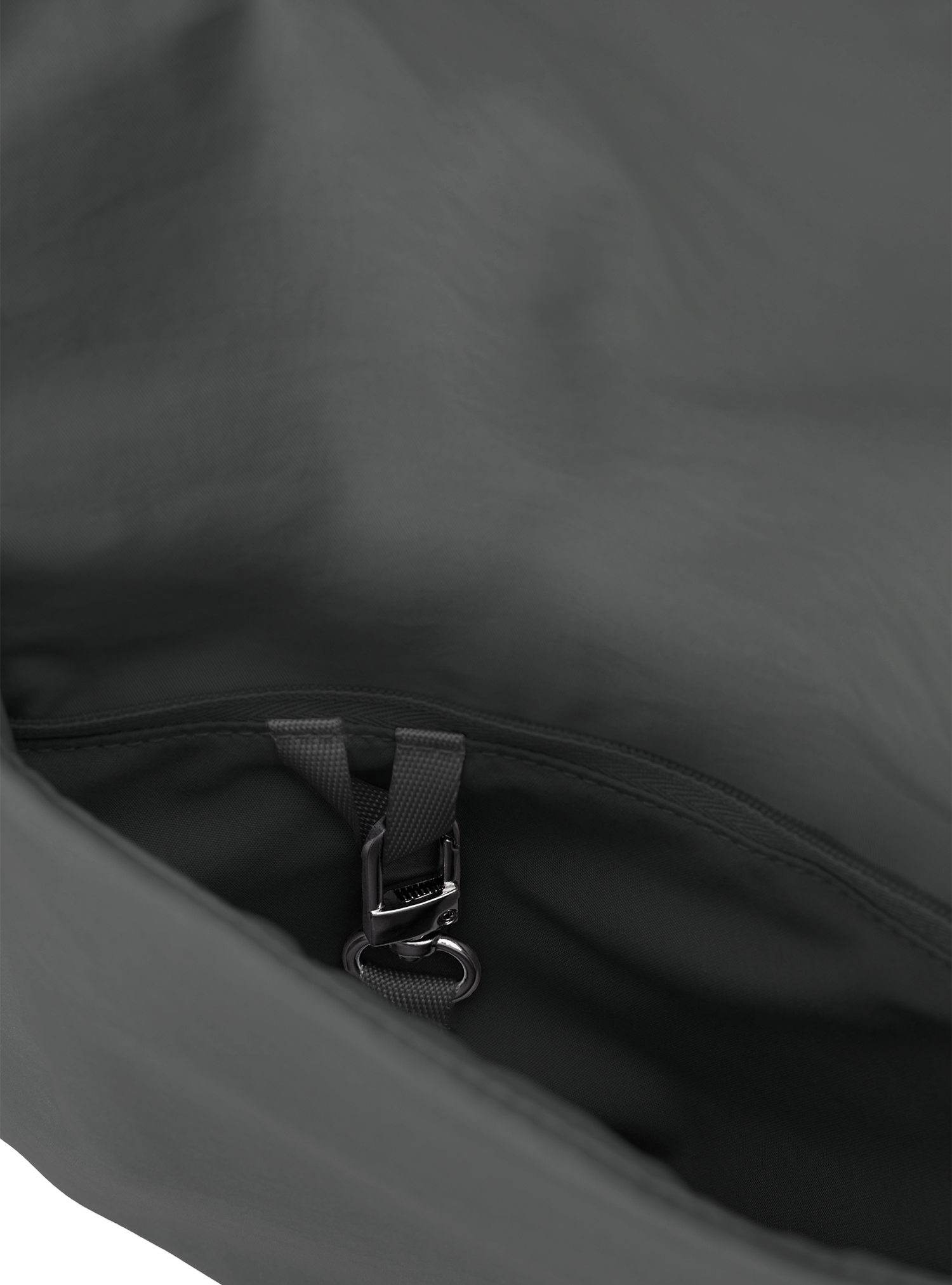 Exterior pocket of the Midi Arc hobo-style bag in dark grey nylon, with concealed snap loop