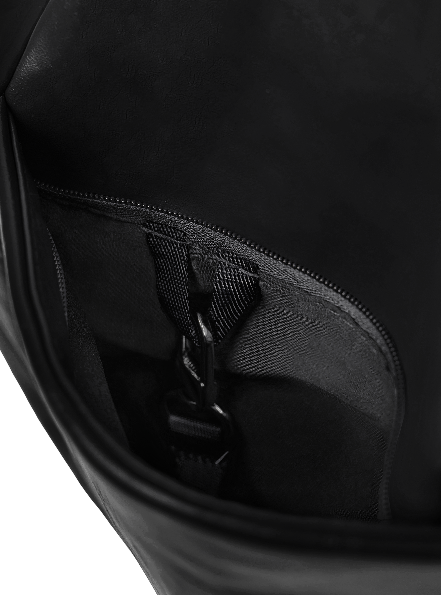 Exterior pocket of the Midi Arc hobo-style bag in matte black vegan leather, with concealed snap loop