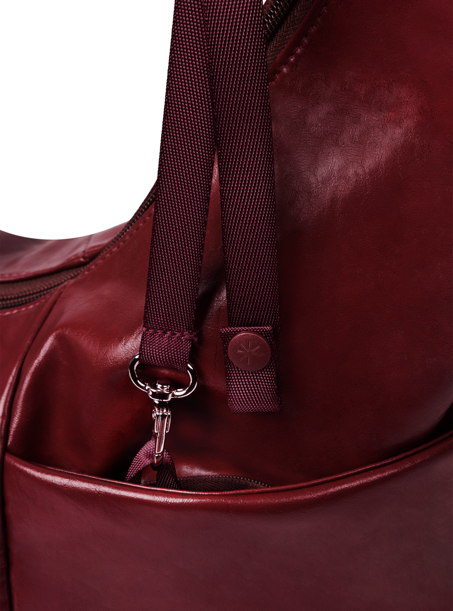 Exterior pocket of the Midi Arc hobo-style bag in wine red vegan leather, with concealed snap loop