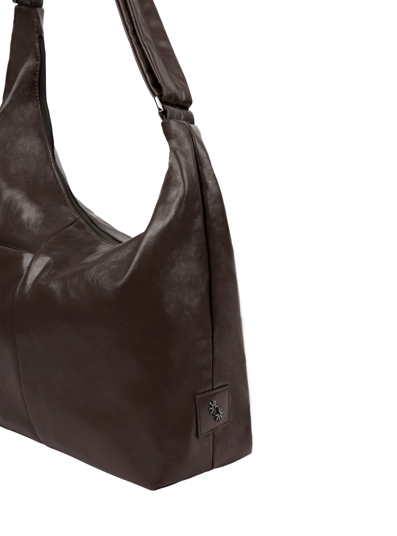 Close-up of the Midi Arc hobo-style bag in dark brown vegan leather, showing metal logo emblem