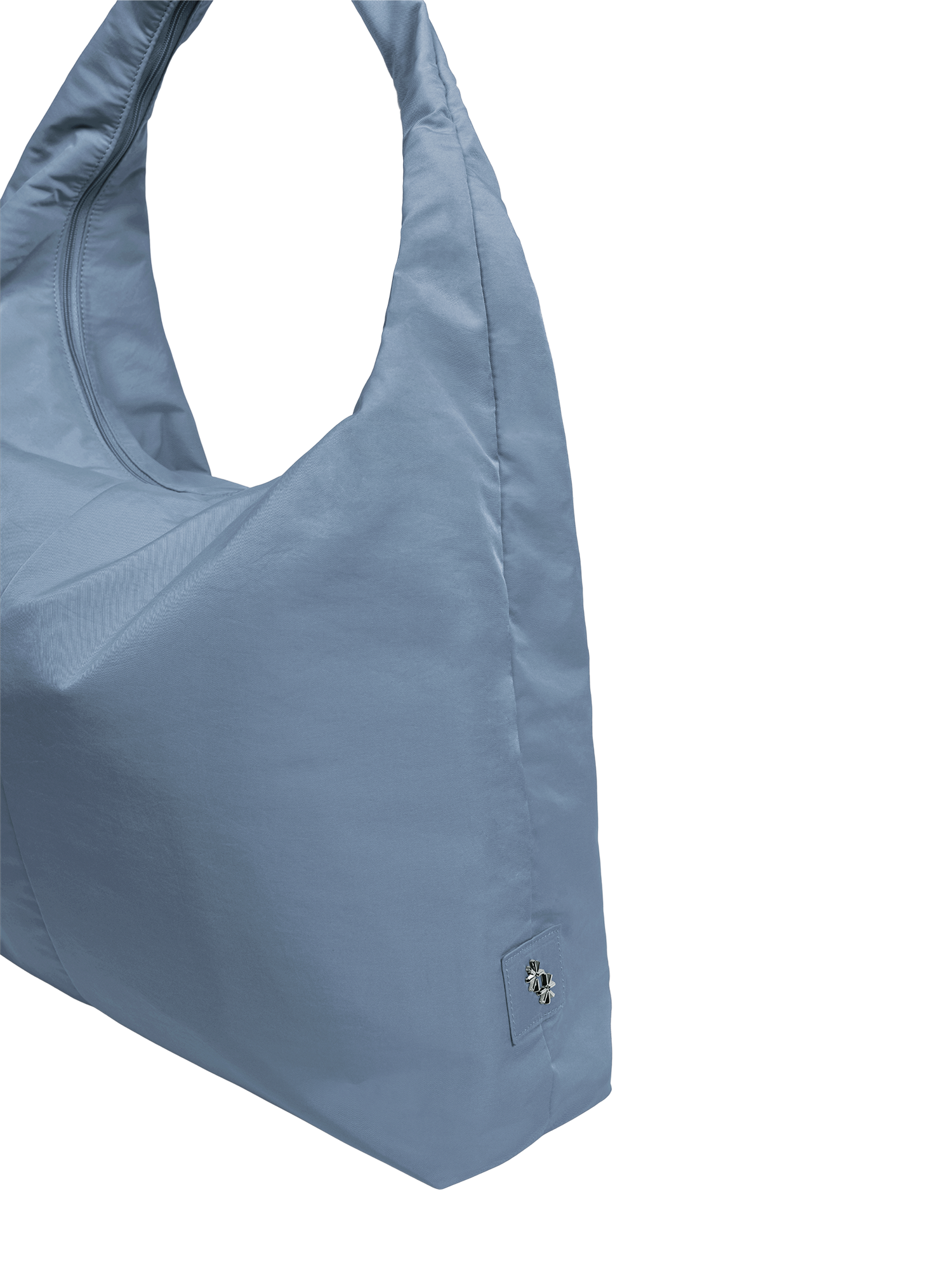 Close-up of the Arc hobo-style bag in grey blue nylon, showing metal logo emblem