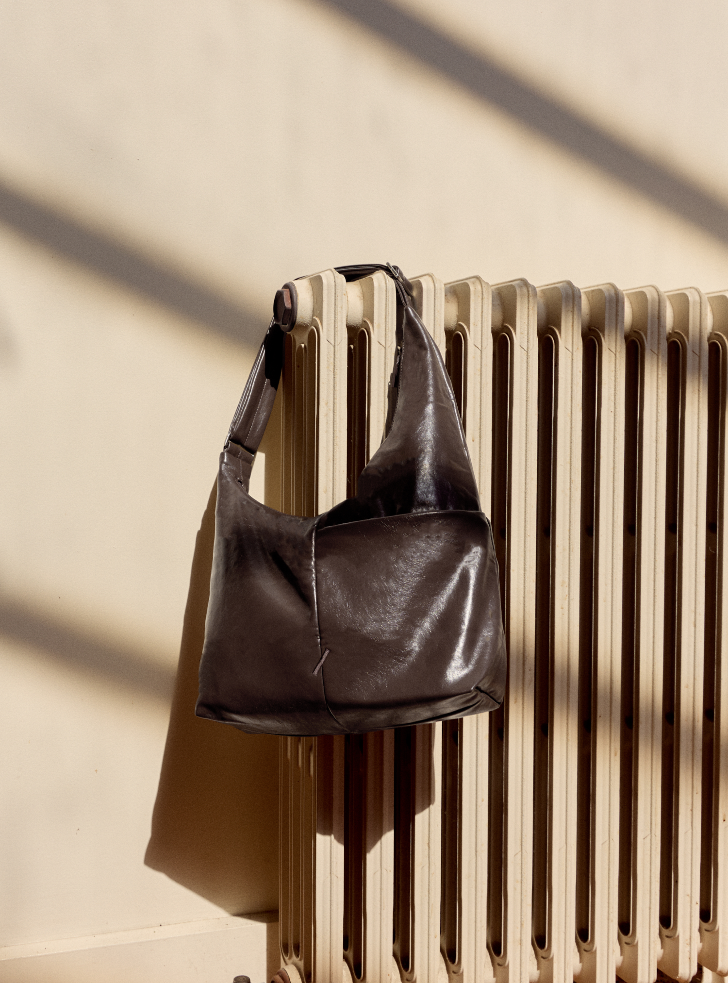 The Midi Arc slouchy hobo bag in dark brown vegan leather for work, travel and everyday use