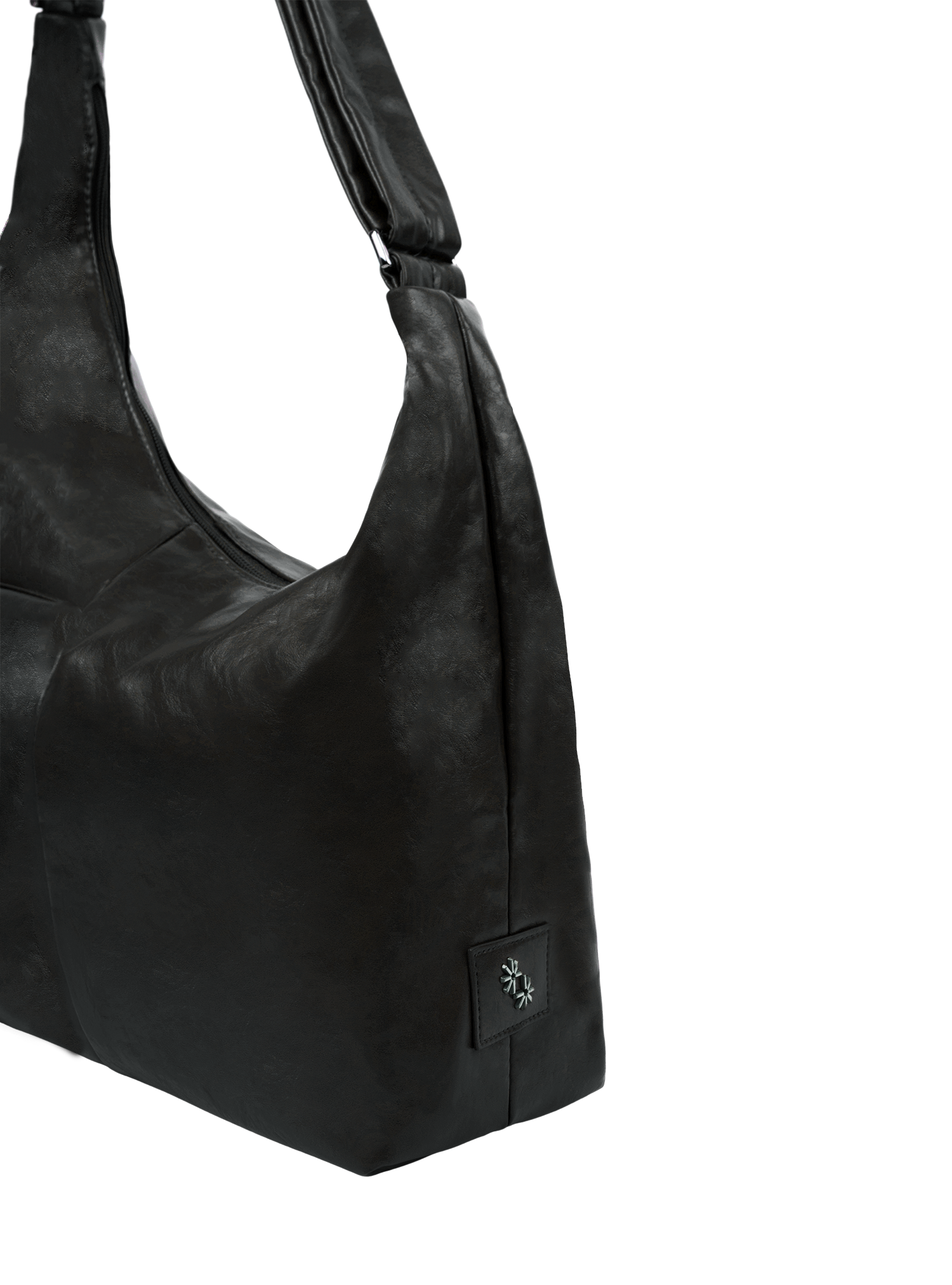 Close-up of the Midi Arc hobo-style bag in matte black vegan leather, showing metal logo emblem